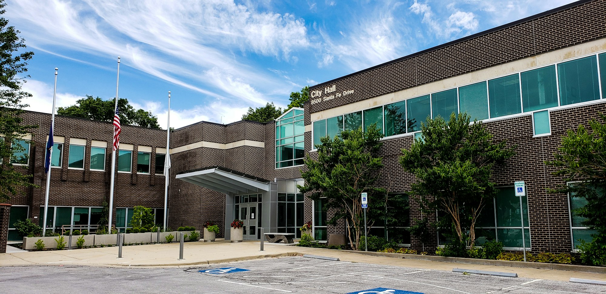 A brick municipal building with large windows, representing Redstone City Hall.
